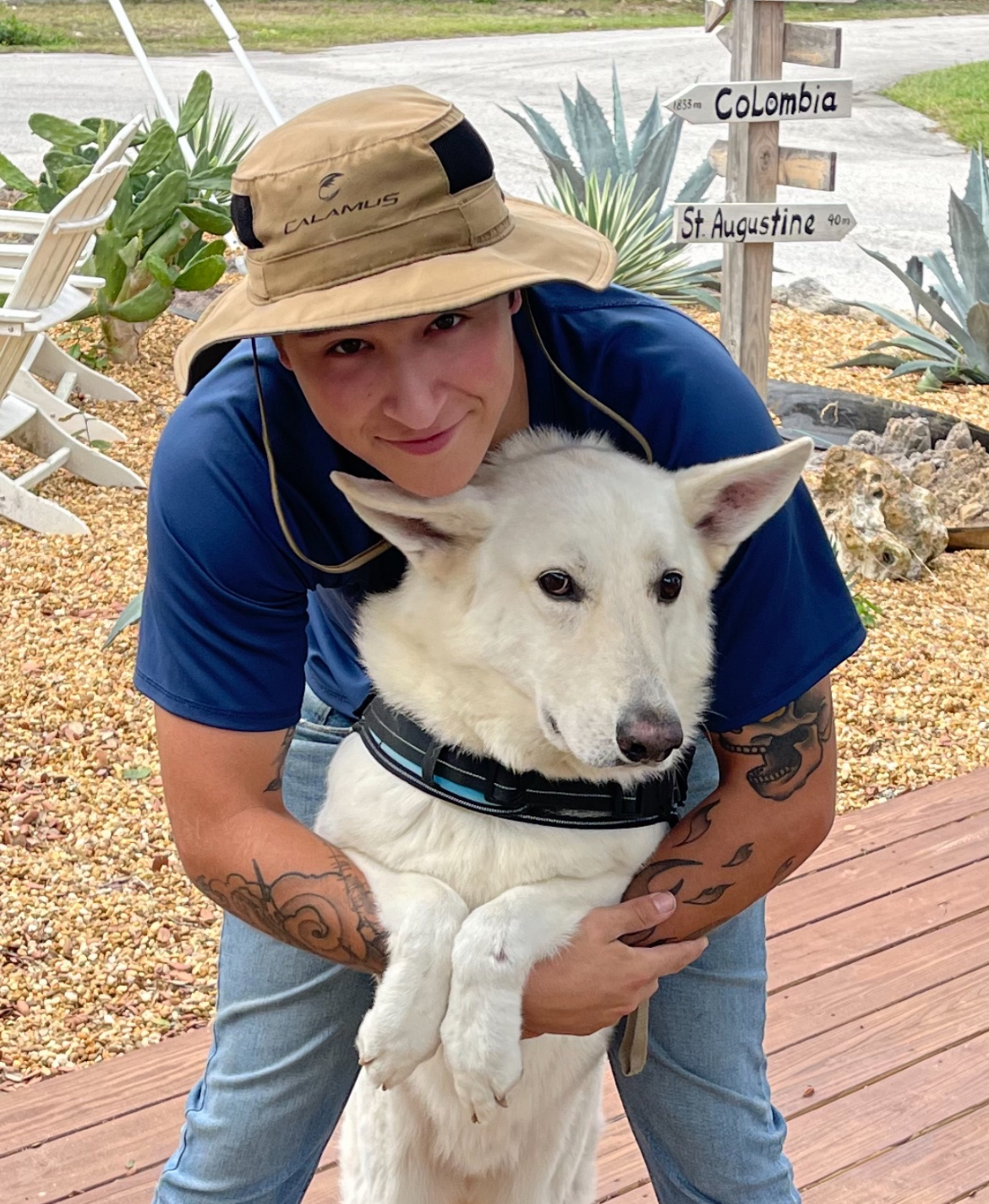 A Gladiator Fence crew member with Ghost, the company's service dog, on-site